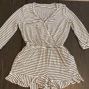About a Girl romper. Size L. Black and white stripe. 1 closure at chest.